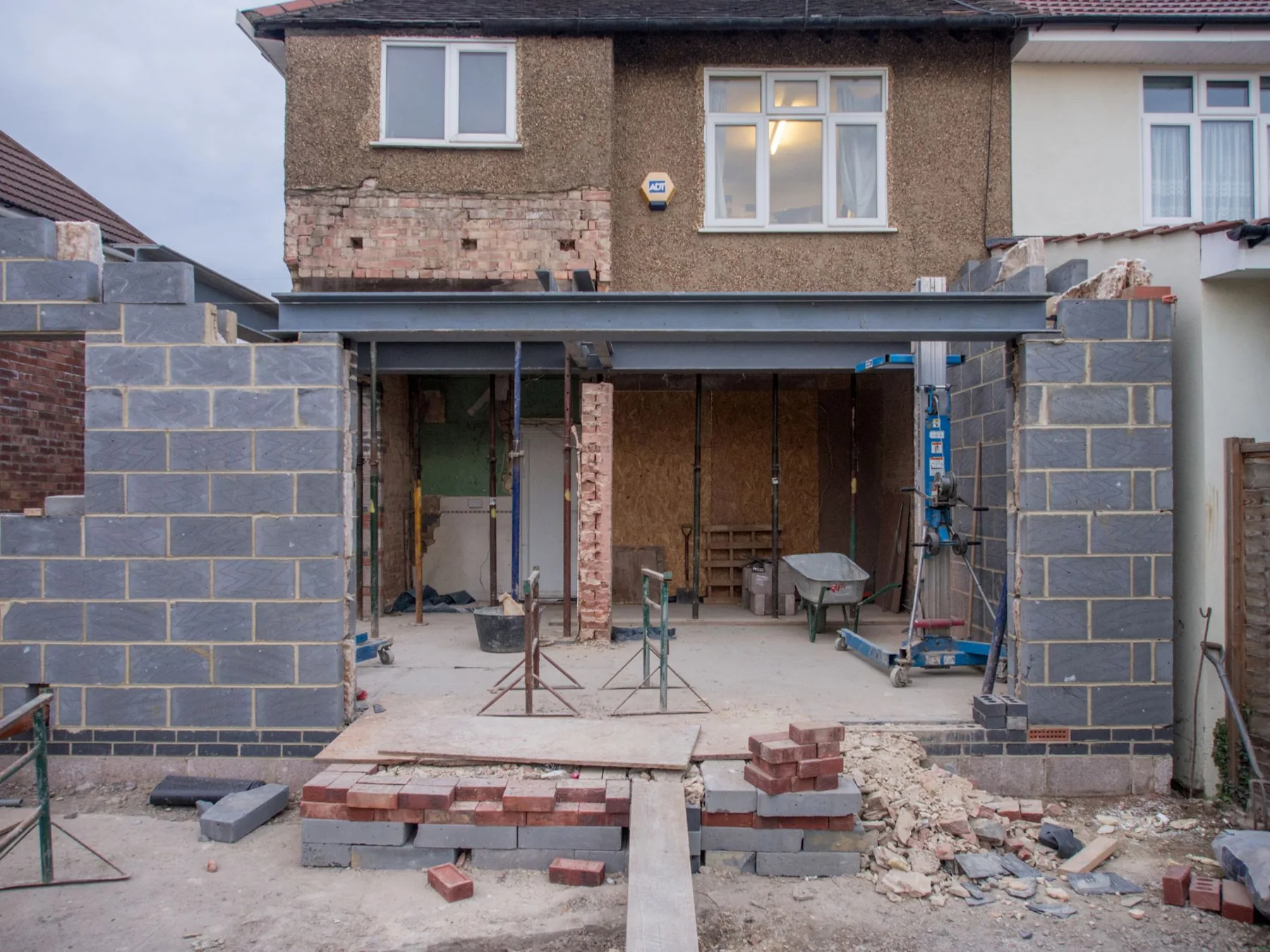 Brick house extension with new blockwork and structural steel beams